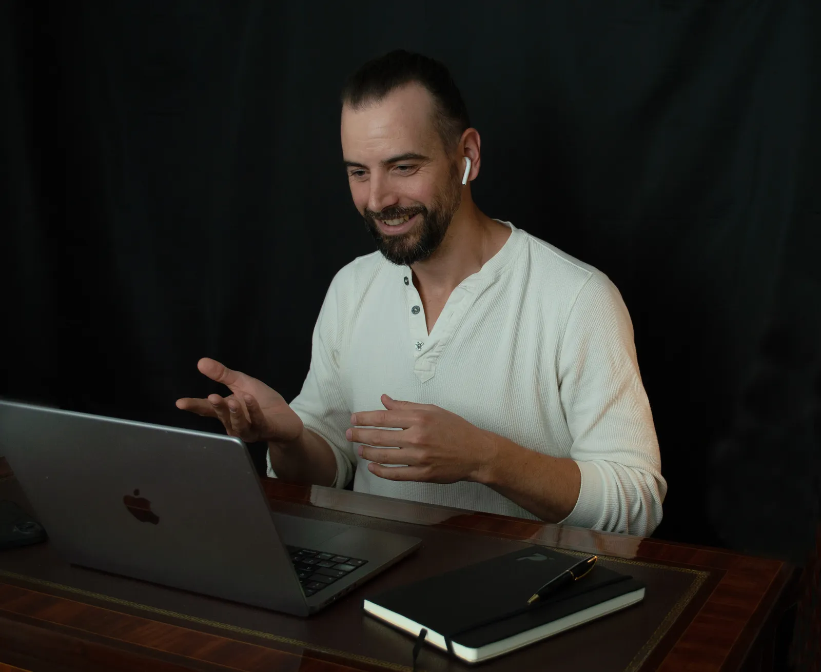 Pete Hogg, MQLFlow's founder, smiling and talking with a client on a video call at his laptop